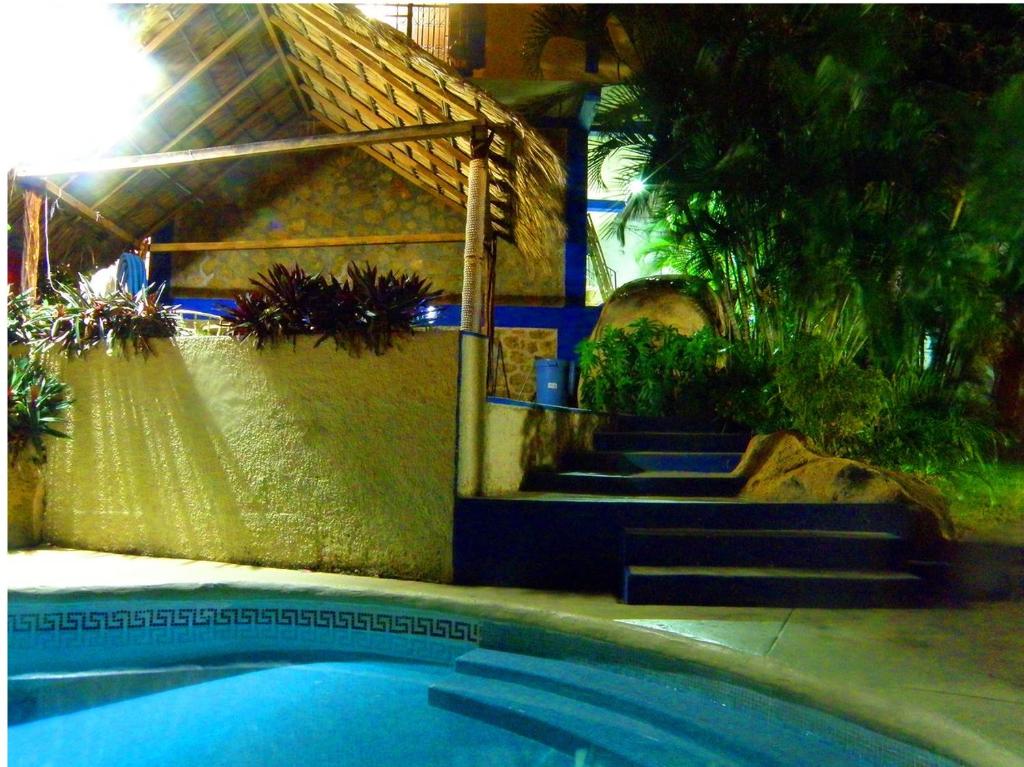 a swimming pool with stairs next to a house at Villas Bahia Dorada in Acapulco