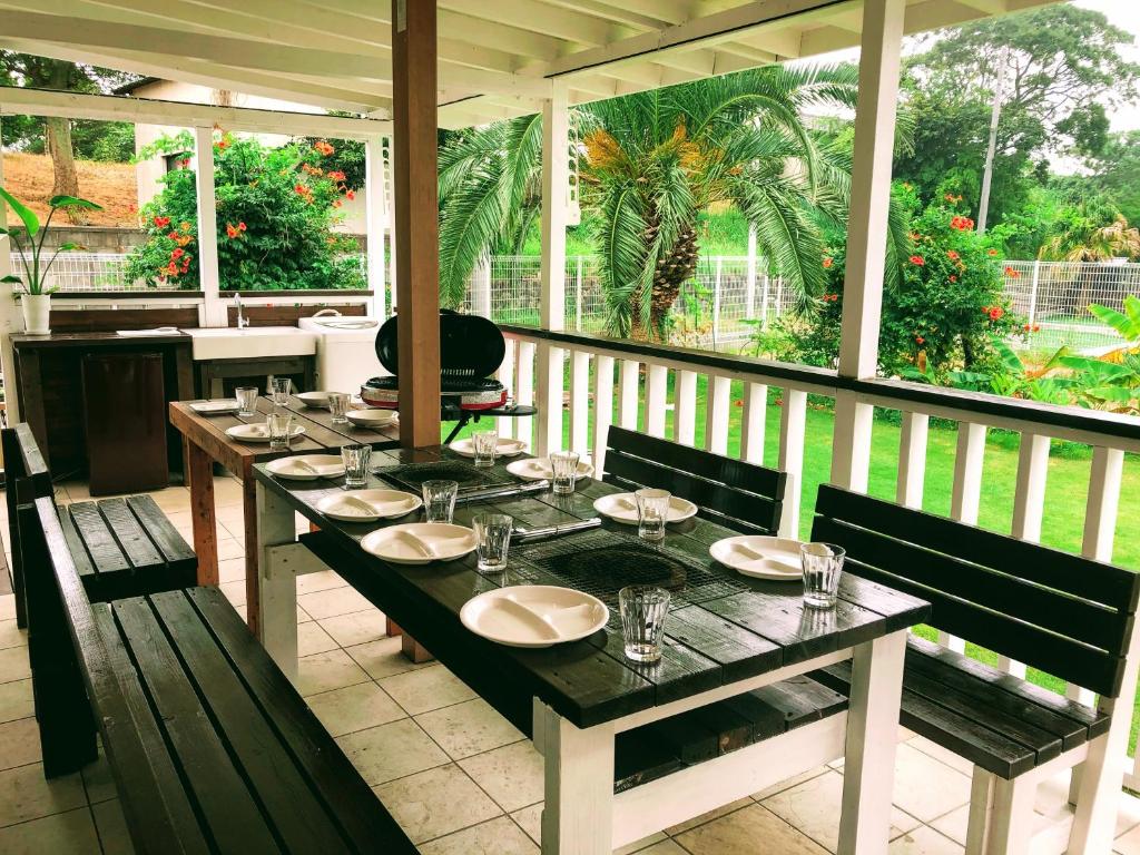 a table on a screened porch with a table and chairs at 海まで3分BBQテラス付き貸別荘 バケーションレンタルハウス Nalu resort Japan in Ichinomiya