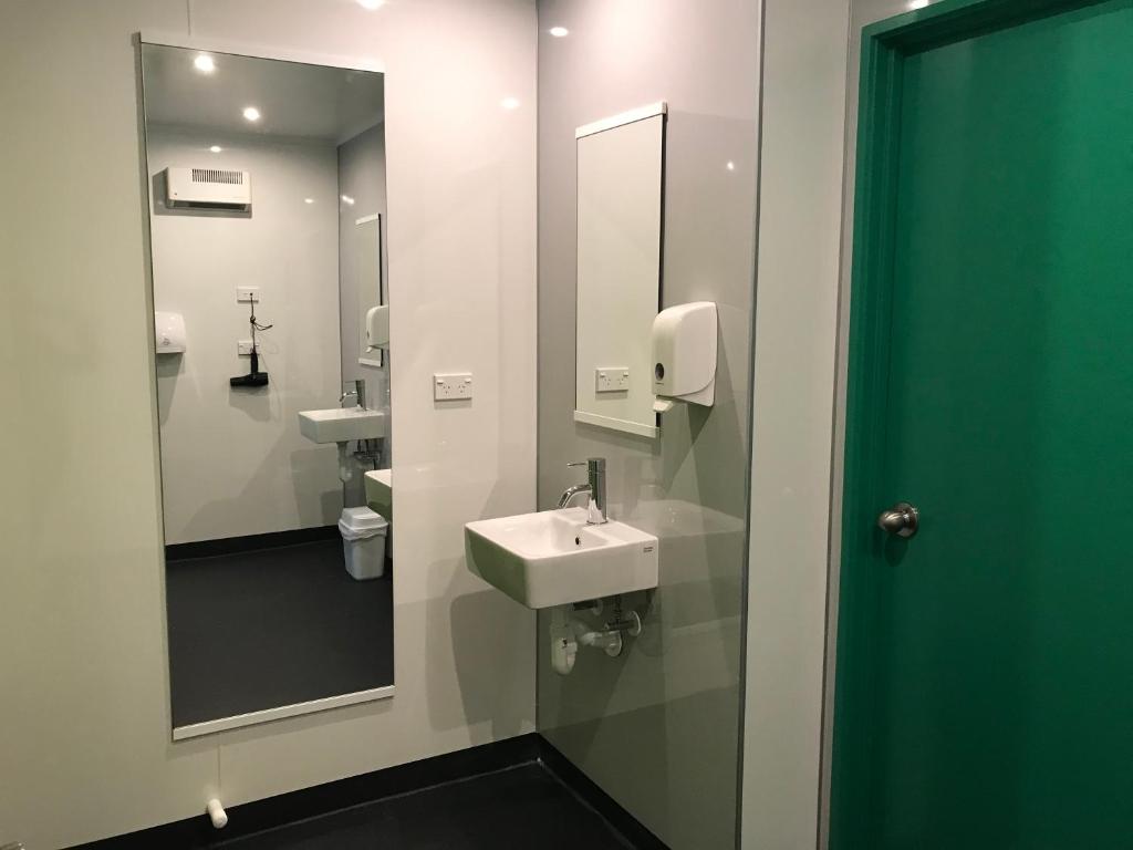 a bathroom with a sink and a mirror at YHA Nelson in Nelson