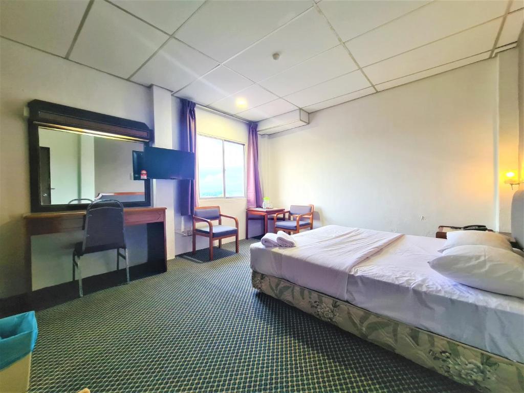 Postel nebo postele na pokoji v ubytování Anika Inn - Kluang