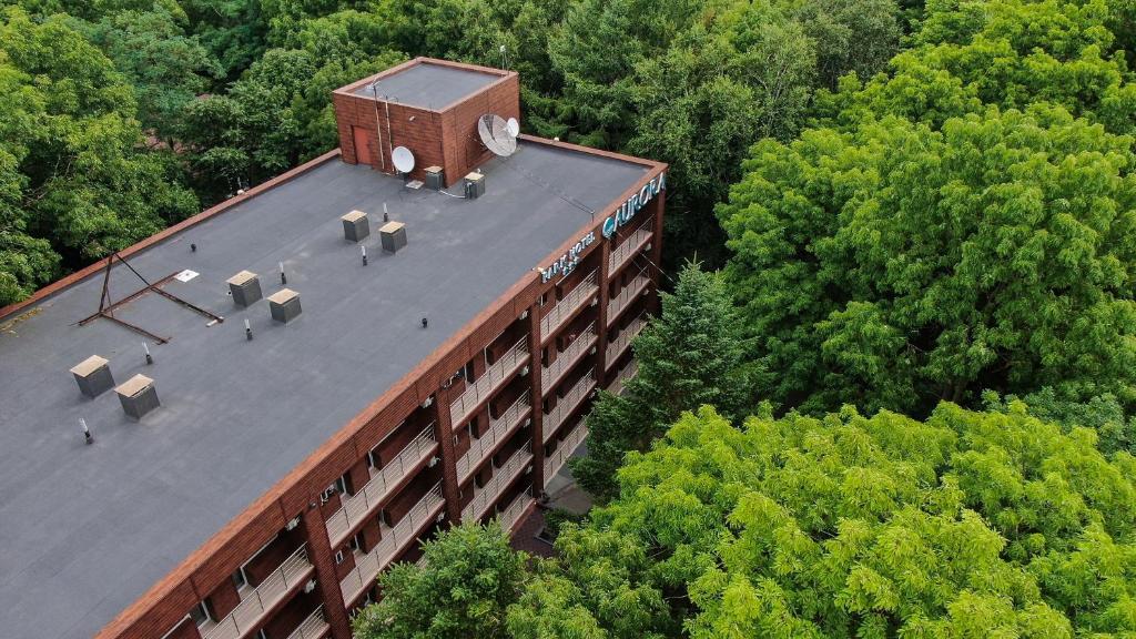 an overhead view of a building with a clock on the roof at Aurora Park Hotel in Vladivostok