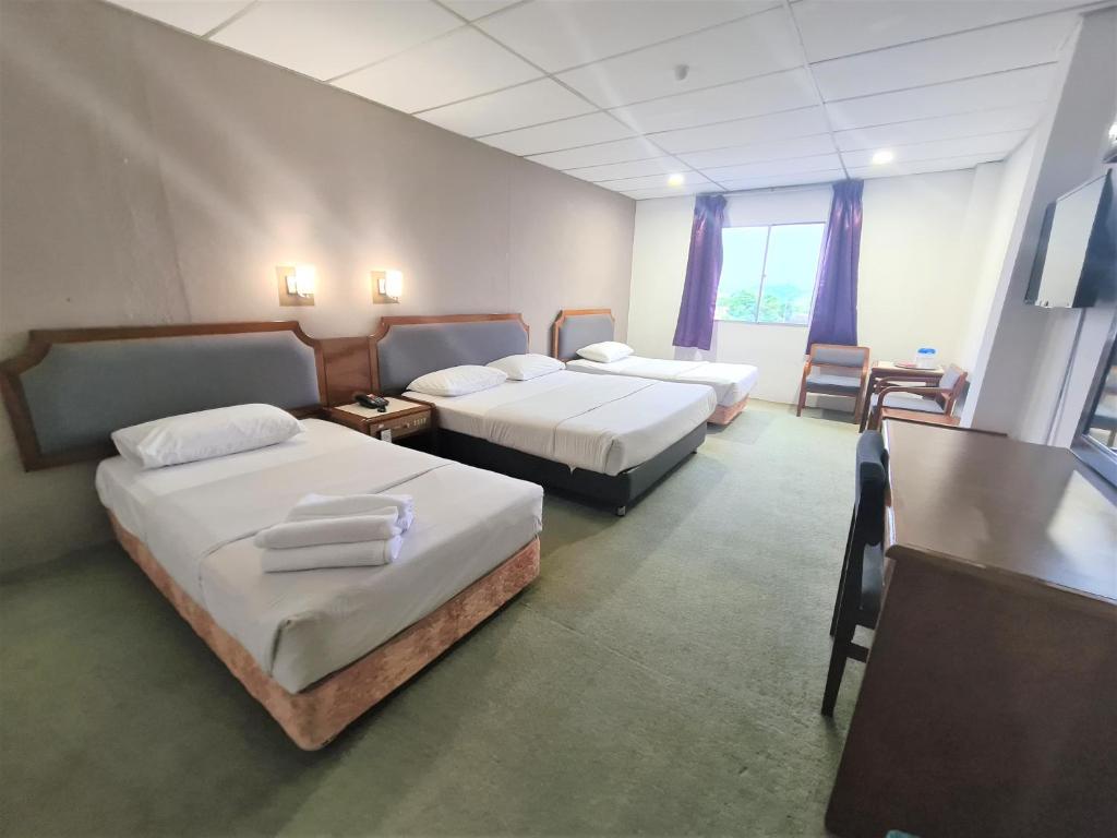 Postel nebo postele na pokoji v ubytování Anika Inn - Kluang