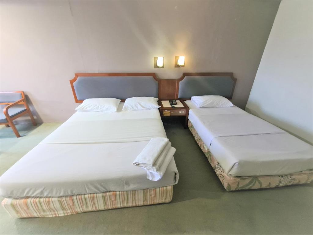 Postel nebo postele na pokoji v ubytování Anika Inn - Kluang
