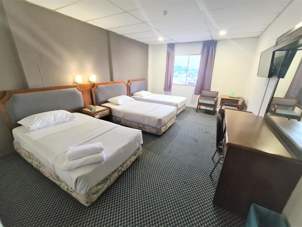 Postel nebo postele na pokoji v ubytování Anika Inn - Kluang