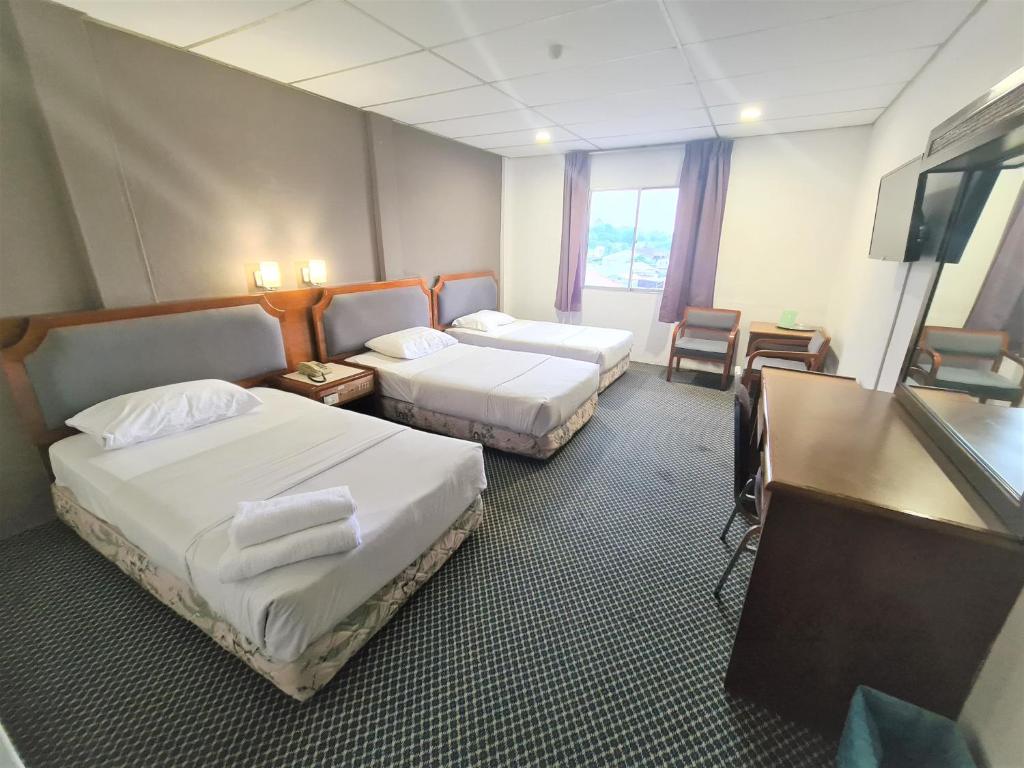 Postel nebo postele na pokoji v ubytování Anika Inn - Kluang