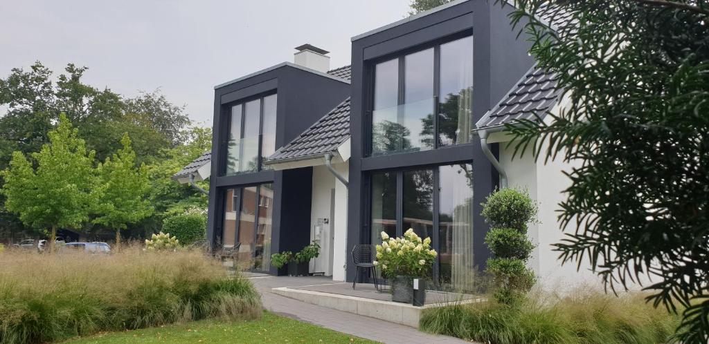 a black and white house with glass windows at Intermezzo Emmerich in Emmerich