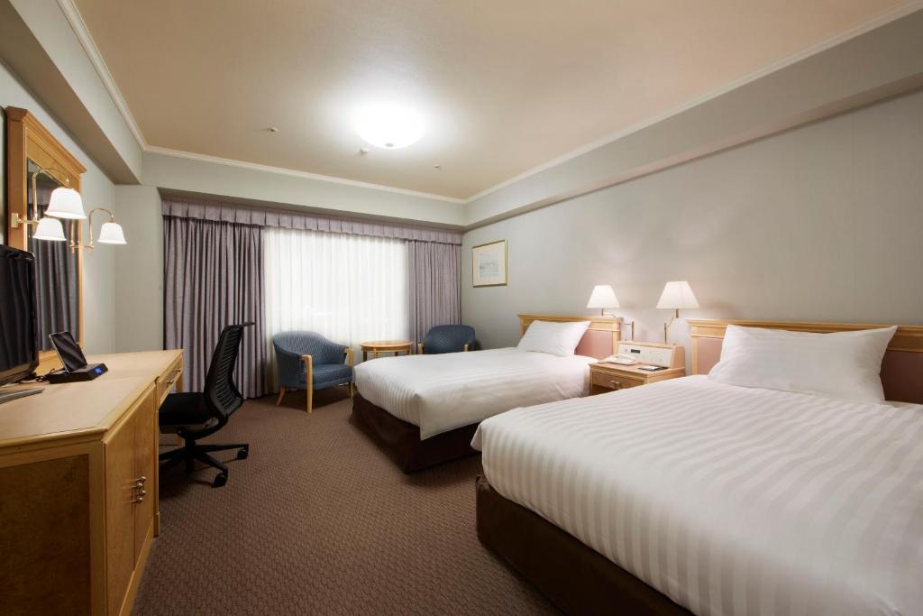 Postel nebo postele na pokoji v ubytování Hotel Agora Regency Osaka Sakai