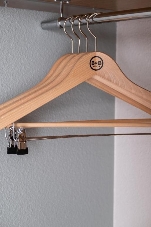 a pair of wooden utensils hanging from a rack at B&B HOTEL Ouistreham in Ouistreham