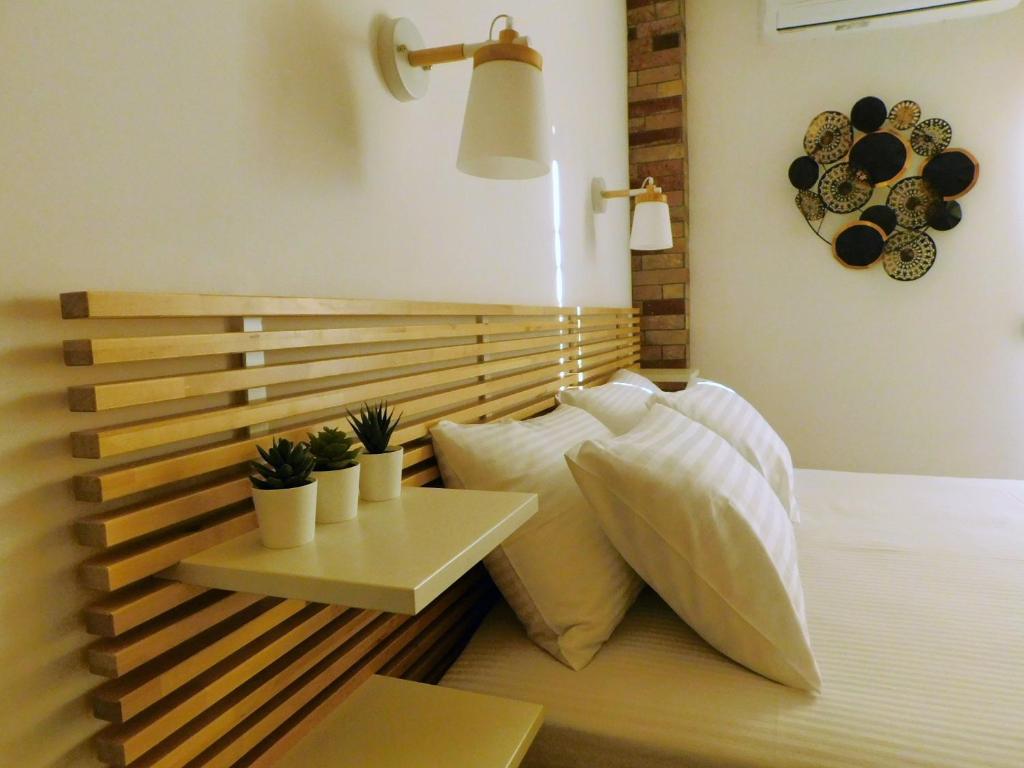 a bedroom with a bed with a table and pillows at Brand New Studio 3 in Komotini