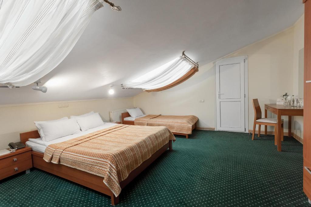 Postel nebo postele na pokoji v ubytování Residence Odesskij Dvorik