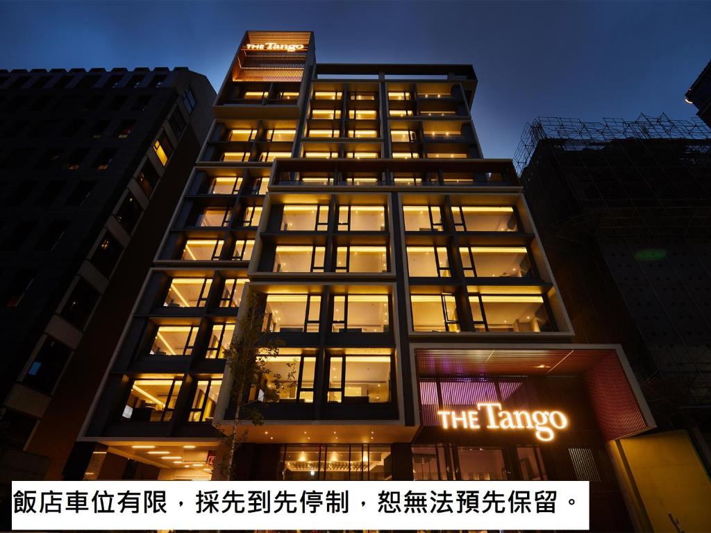 a tall building with a sign on it at The Tango Hotel Taipei Jiantan in Taipei