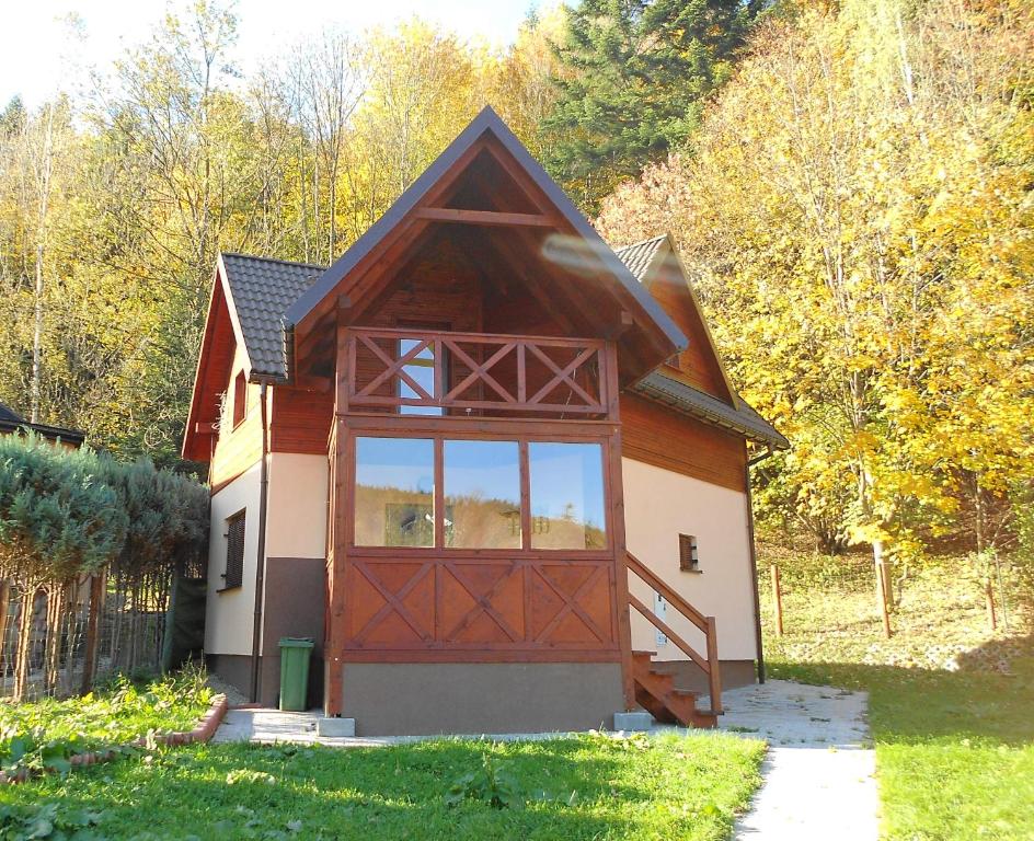 a small house with a large window on the side of it at Zawoja Chaty Górskie D5 in Zawoja