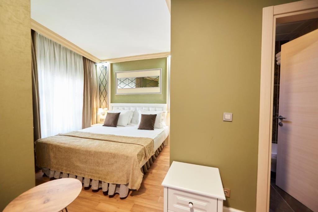 Postel nebo postele na pokoji v ubytování Sunlight Hotel