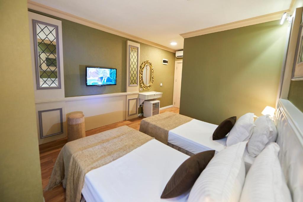 Postel nebo postele na pokoji v ubytování Sunlight Hotel