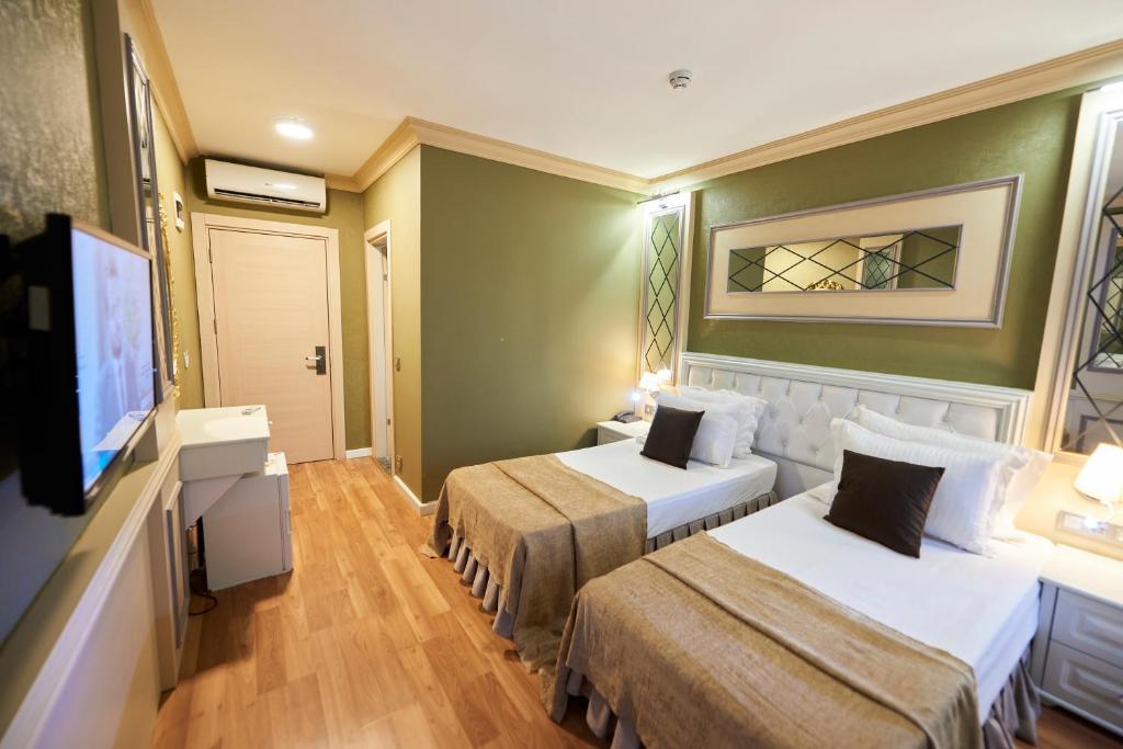Postel nebo postele na pokoji v ubytování Sunlight Hotel