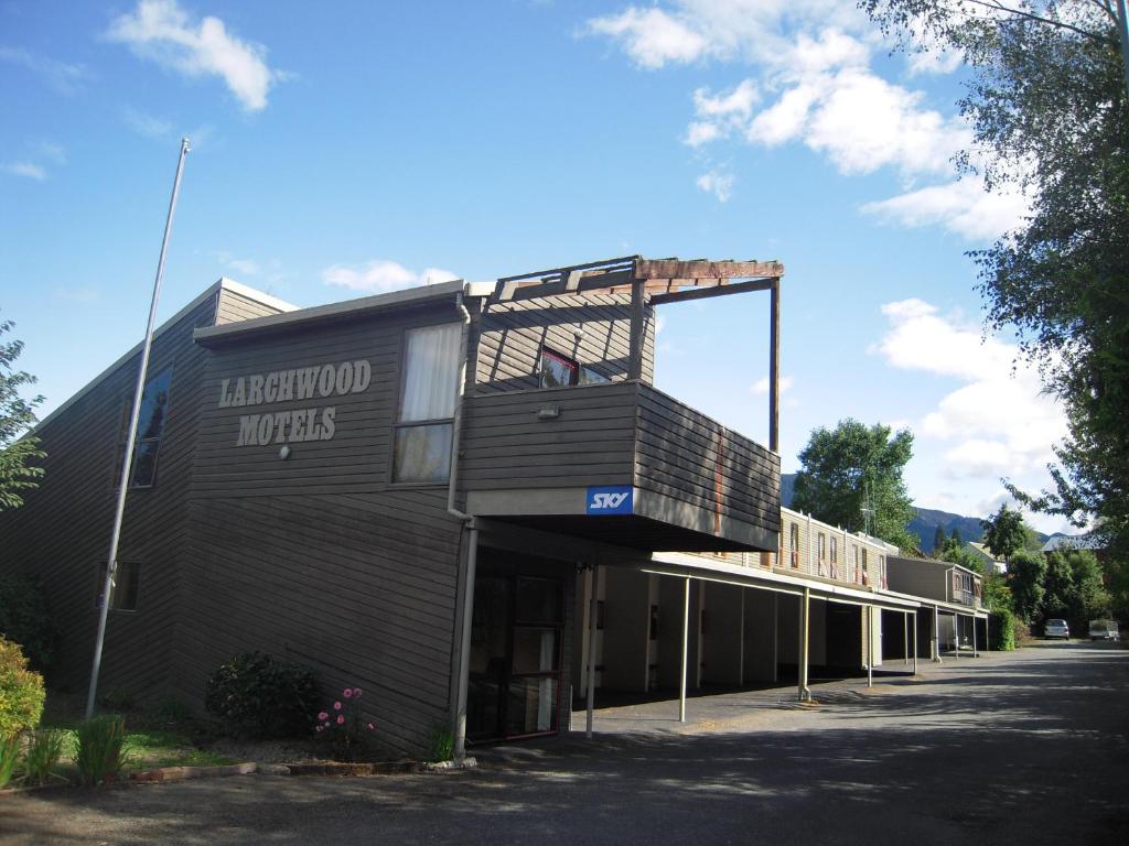 a building with a sign on the front of it at Larchwood Motel in Hanmer Springs