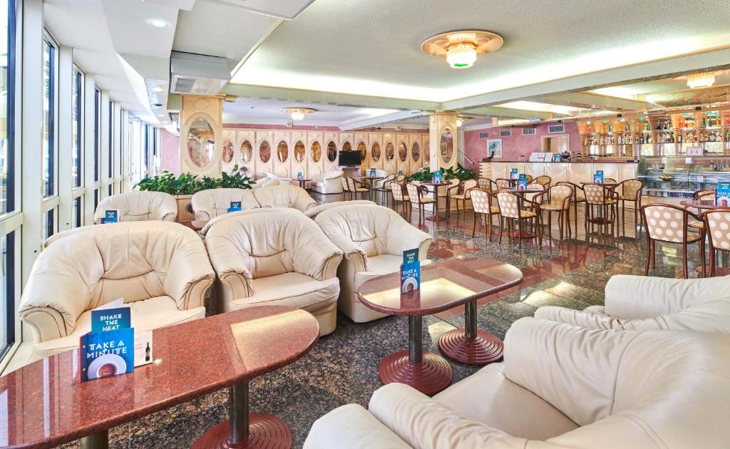 a waiting room with white couches and tables at Hotel Istra Plava Laguna in Poreč