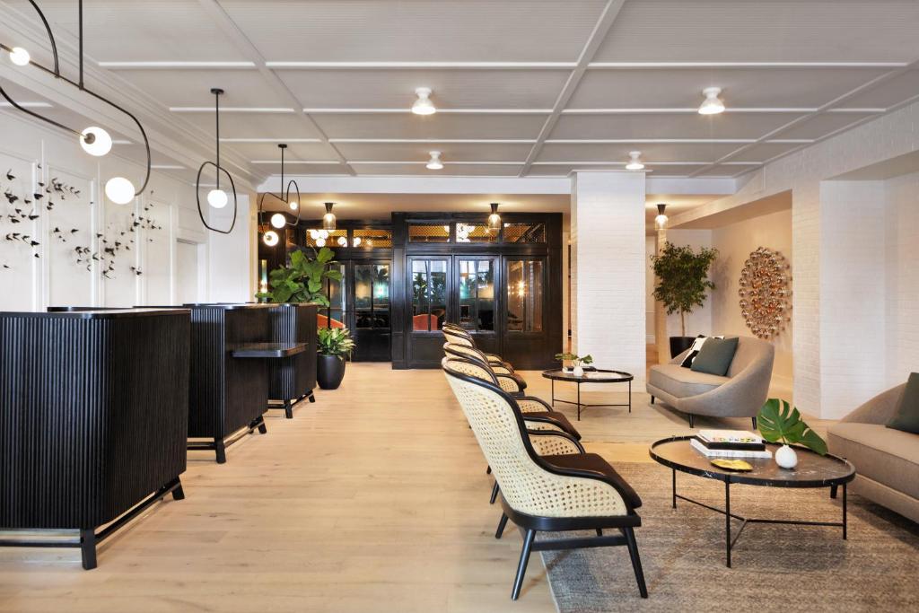 a lobby with a row of chairs and a table at Kimpton Hotel Fontenot, an IHG Hotel in New Orleans