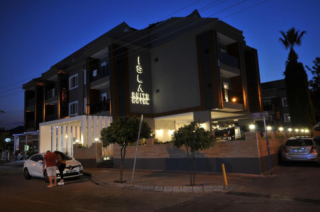 a man standing in front of a building with a car at Isla Apart in Marmaris