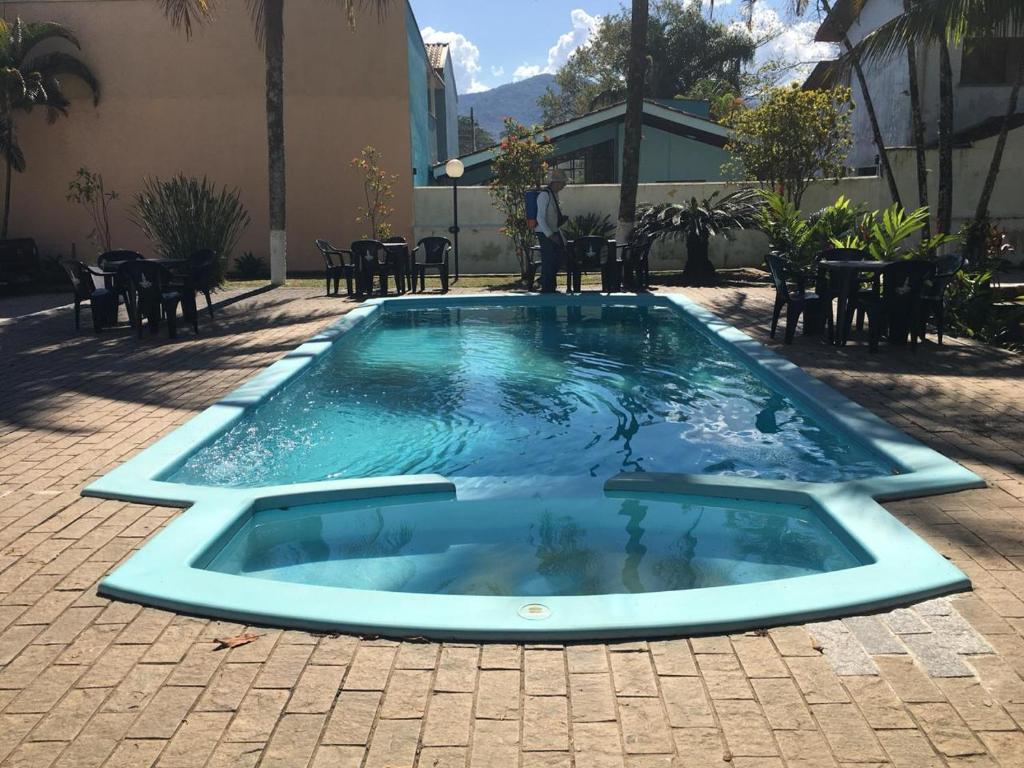 a swimming pool in the middle of a patio at Pousada Flor de Jambo in Ubatuba
