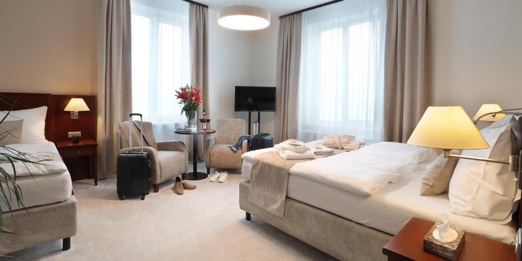 Postel nebo postele na pokoji v ubytování Hotel KOZÁK