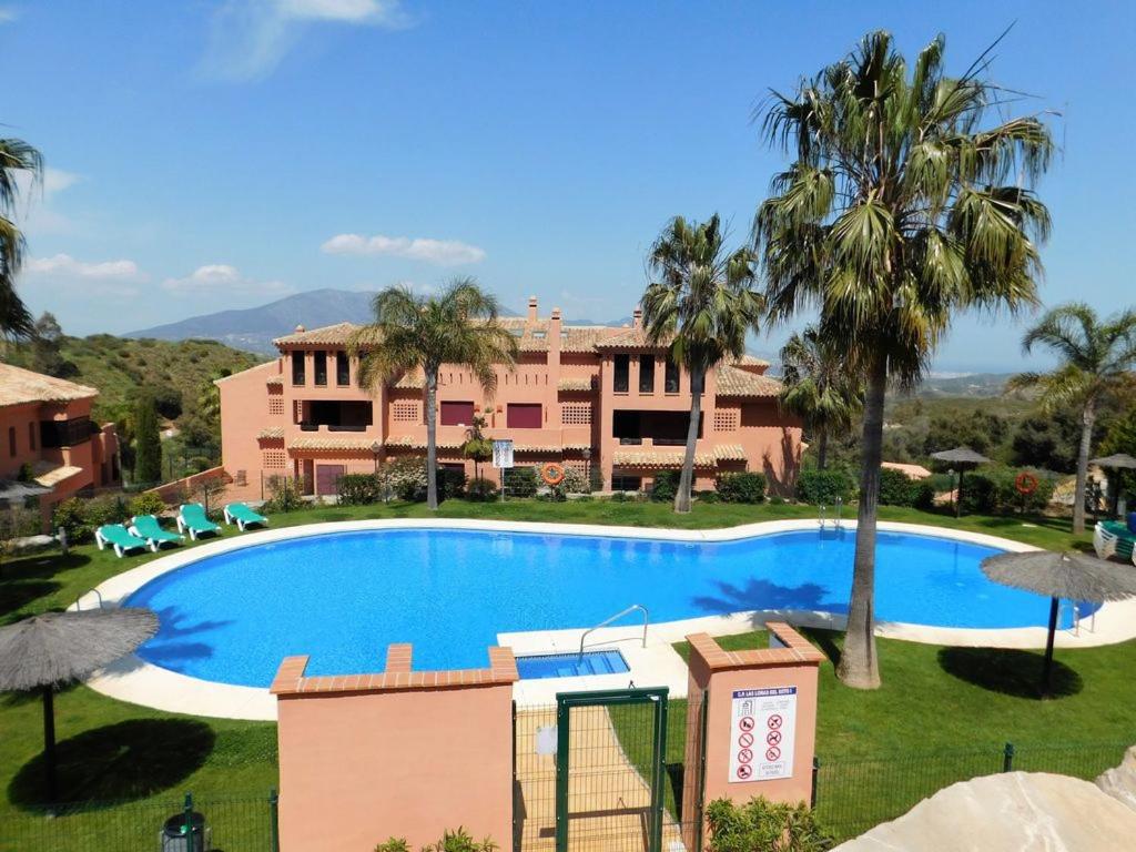 einem großen Pool vor einem Gebäude in der Unterkunft El Soto de Marbella FREE Golf-Tennis-Spa Area 2 Bedroom Penthouse in La Mairena