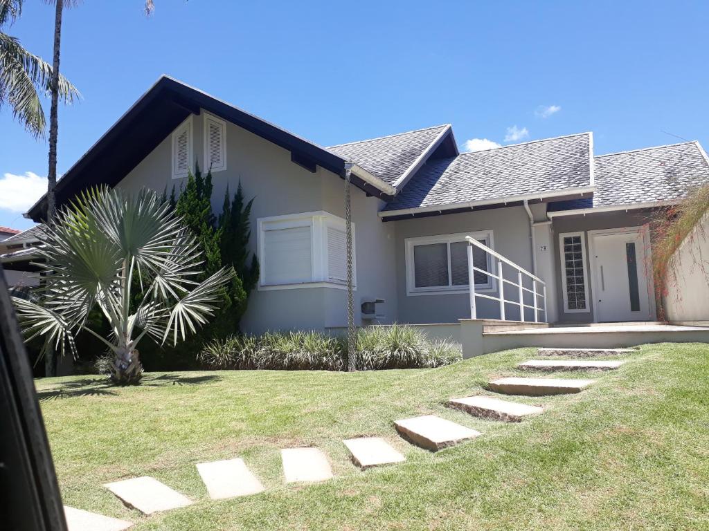 a house with a palm tree in front of it at Pousada Benedicto in Benedito Novo