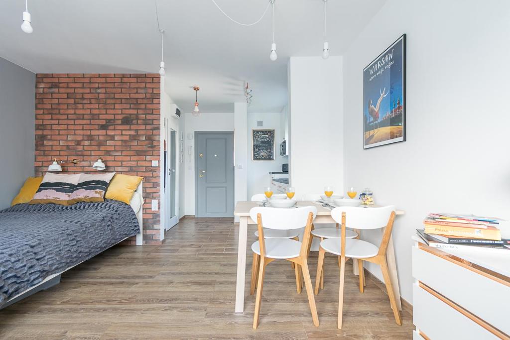 a bedroom with a bed and a table and chairs at Murano Art Home in Warsaw