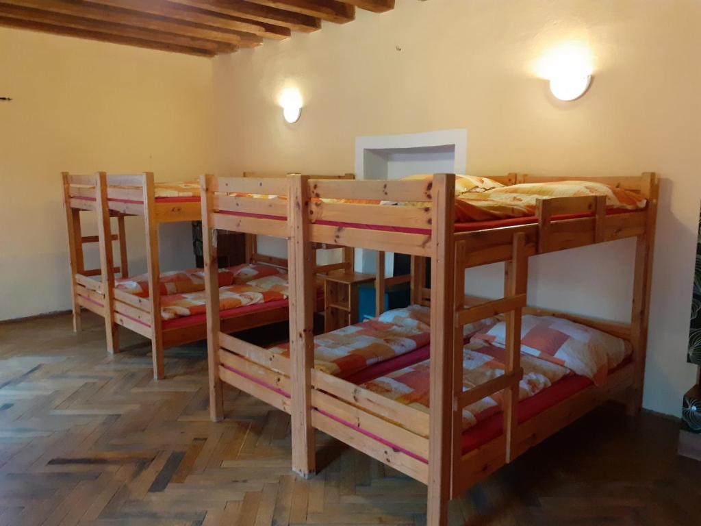 a group of bunk beds in a room at Hostel Skautský dom in Banská Štiavnica