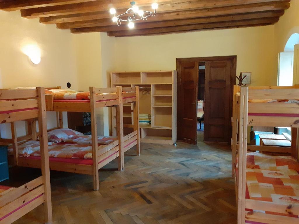 a room with several bunk beds in a room at Hostel Skautský dom in Banská Štiavnica