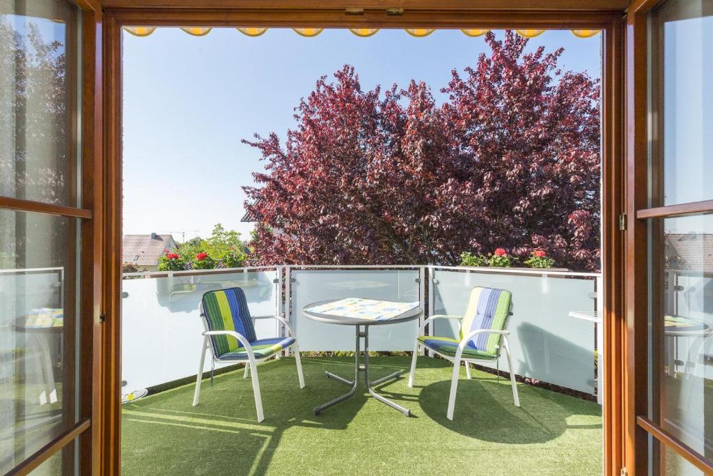 a patio with two chairs and a table on a balcony at 1 Zimmer Ferienwohnung Baur Nr 3 in Salem