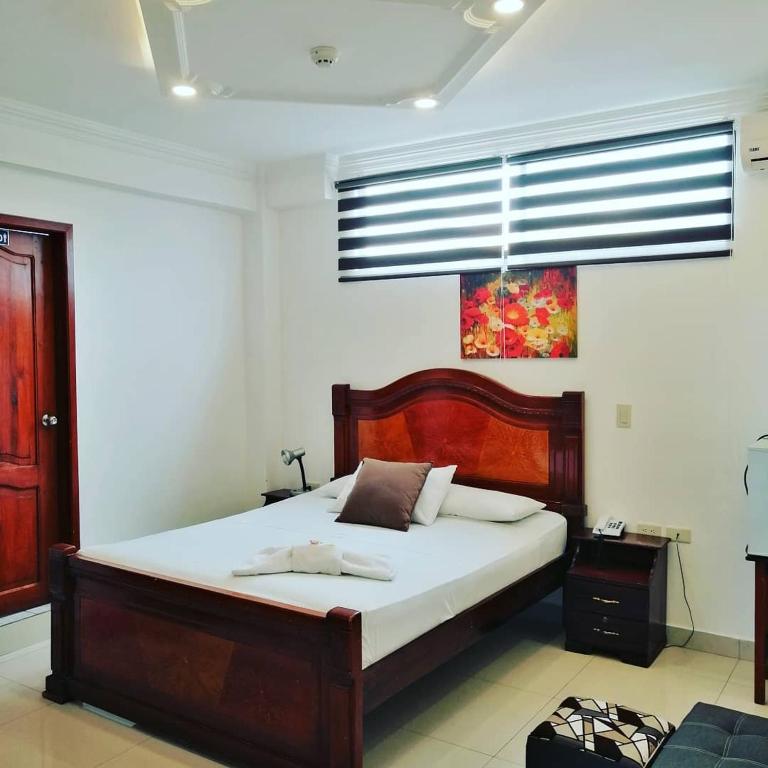 Postel nebo postele na pokoji v ubytování Hostal Perla Real Inn