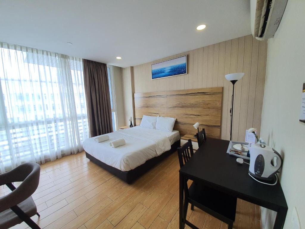 Postel nebo postele na pokoji v ubytování Bangi Perdana Hotel