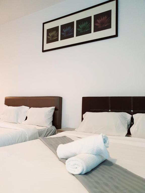 Postel nebo postele na pokoji v ubytování Bangi Perdana Hotel