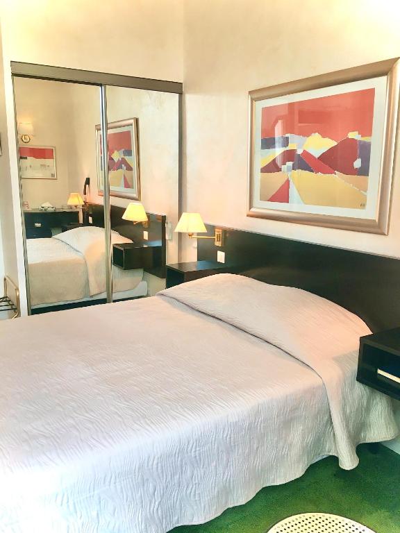 Postel nebo postele na pokoji v ubytování Hotel des Mimosas