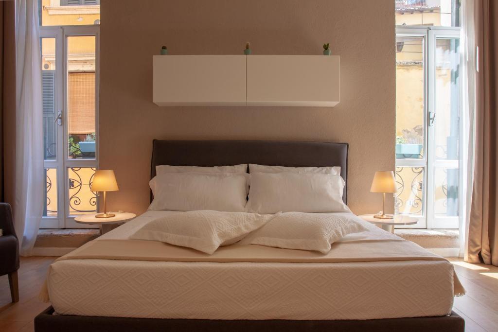 Posteľ alebo postele v izbe v ubytovaní Domus Suites Verona