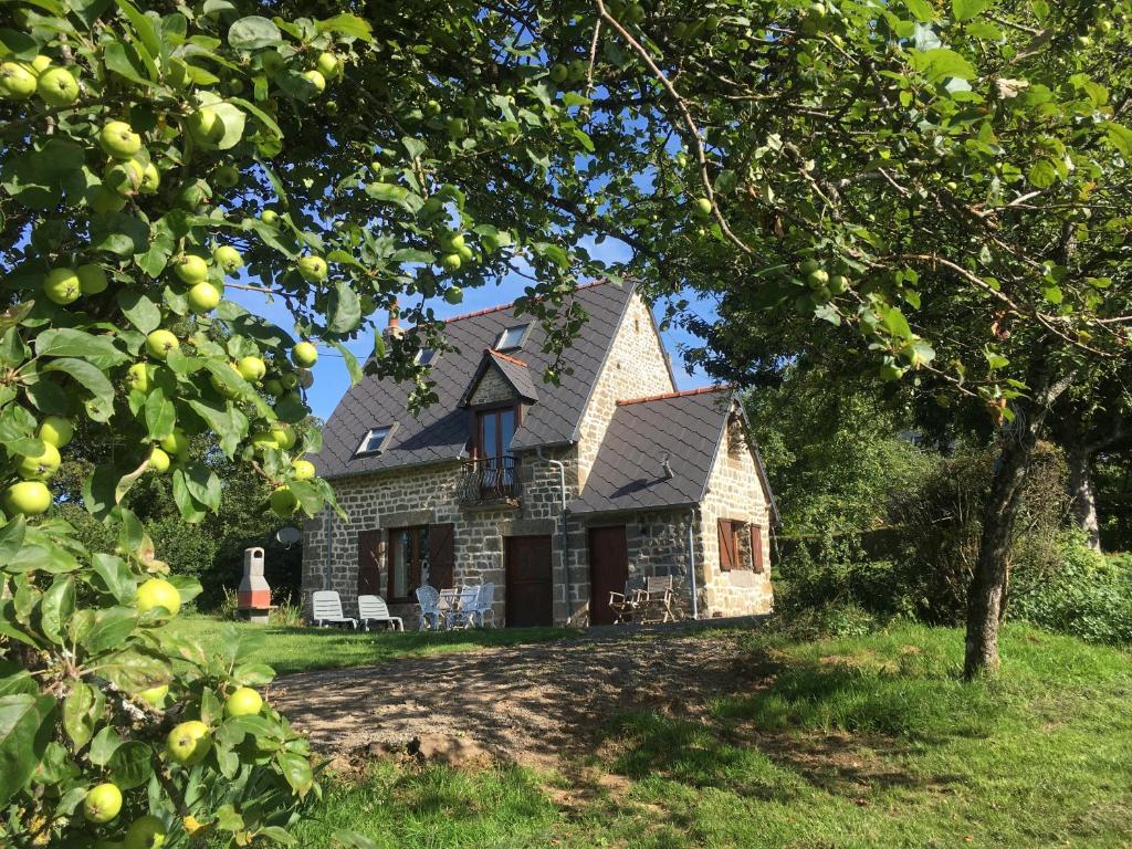 a stone house with a gambrel roof at The Gingerbread House Cottage in Beauficel