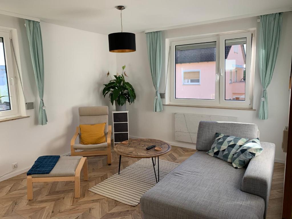 a living room with a couch and a table at Ferienwohnung Fridolin in Bad Staffelstein