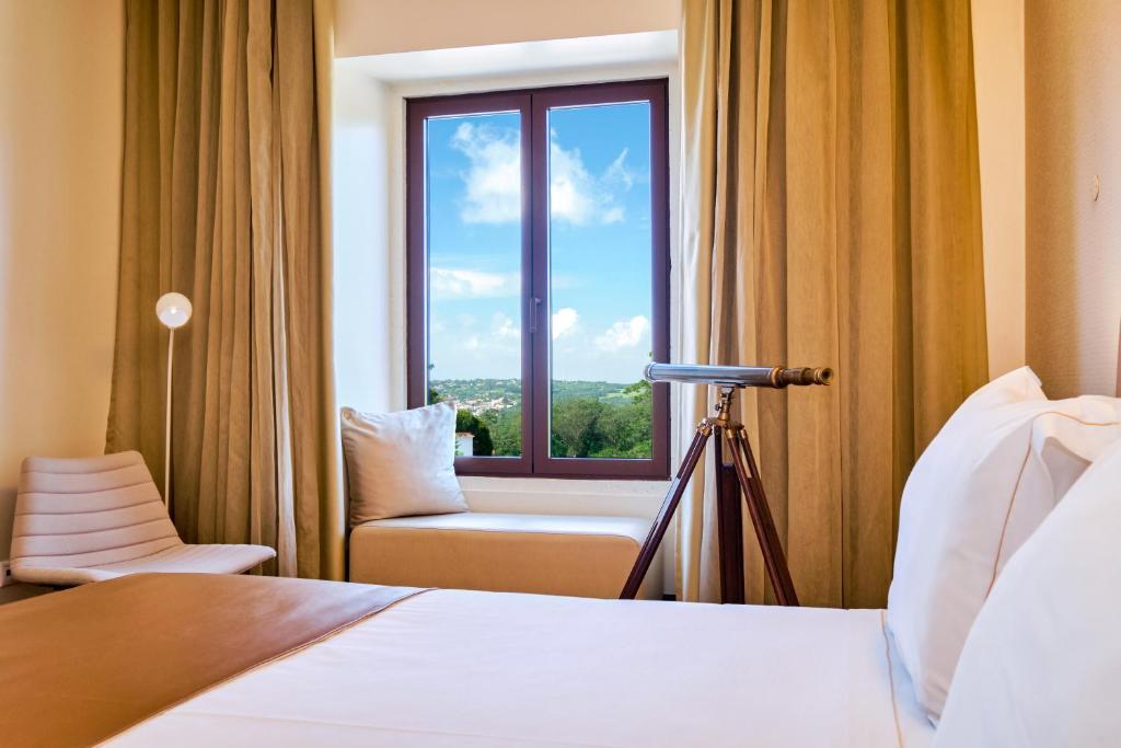 a hotel room with a bed and a window at Sintra Boutique Hotel in Sintra