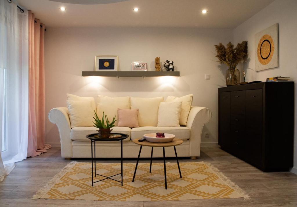 a living room with a white couch and a table at Apartament Sobieski in Sanok