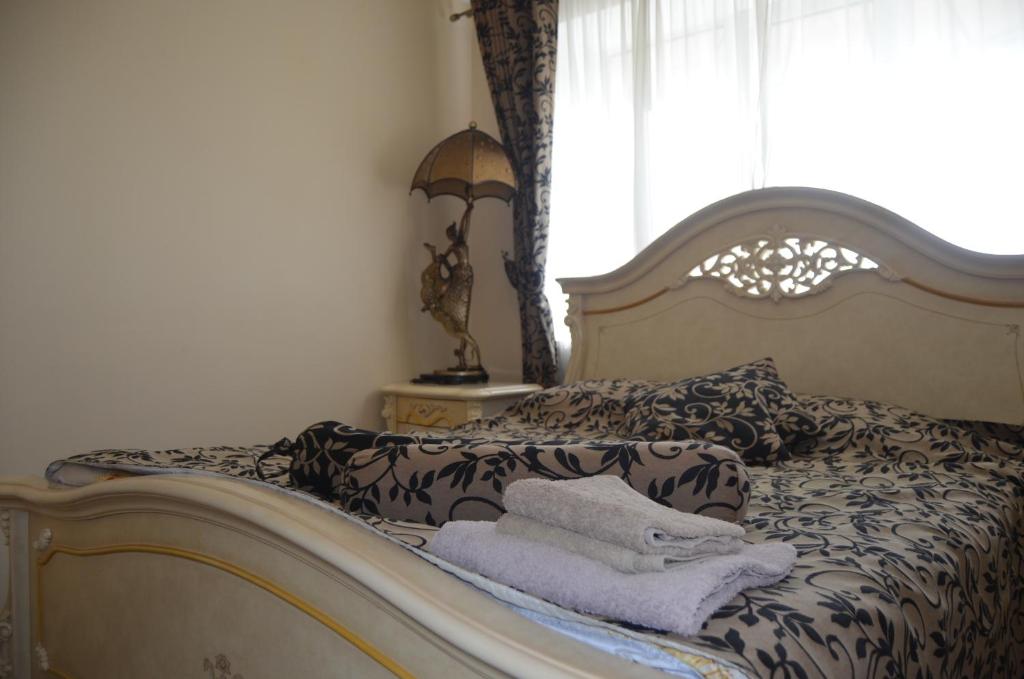a bedroom with a bed with towels on it at Бізнес Центр & Готель в Центрі Міста in Umanʼ