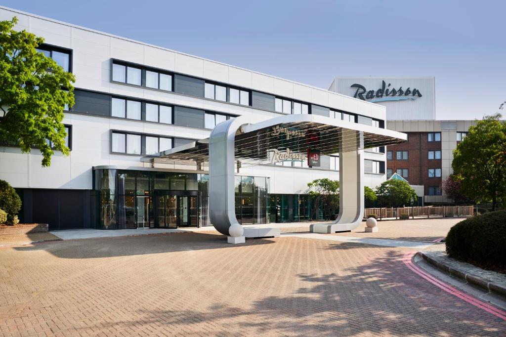 a large white building with a pavilion in front of it at Radisson Hotel and Conference Centre London Heathrow in Hillingdon