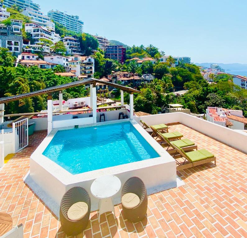 a swimming pool on the roof of a house at Hotel Amaca Puerto Vallarta - Adults Only in Puerto Vallarta
