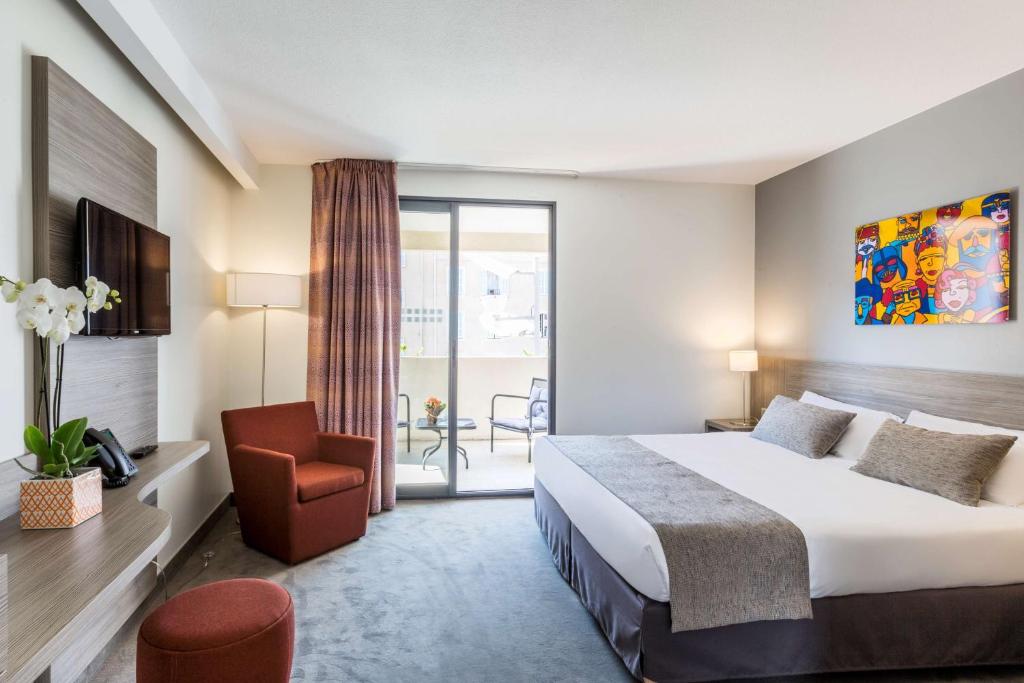 une chambre d'hôtel avec un lit et une chaise dans l'établissement Best Western Linko Aubagne, à Aubagne
