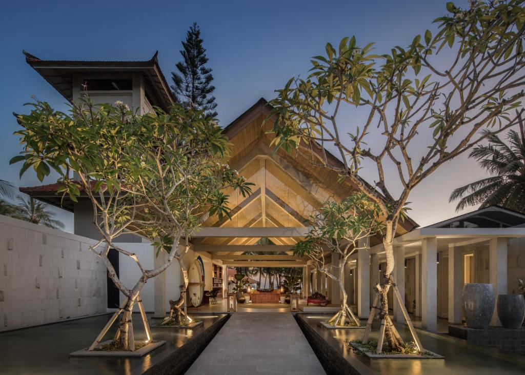 a house with trees in front of it at Umadewi Surf & Retreat in Pulukan