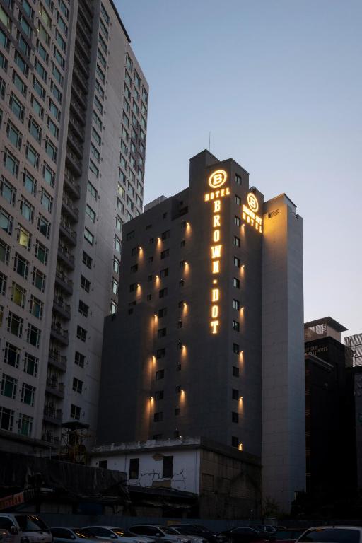 a tall building with lights on the side of it at Seomyeon Brown-dot hotel Gold in Busan