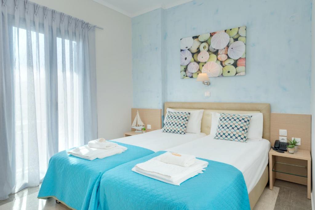 Postel nebo postele na pokoji v ubytování Pyrgos Beach Hotel Apartments