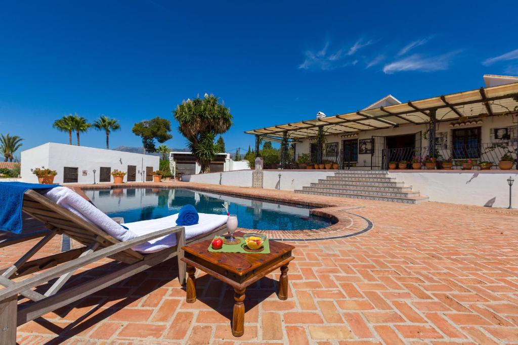 a swimming pool with a chair and a table next to it at Cortijo Boutique Marbella in Marbella