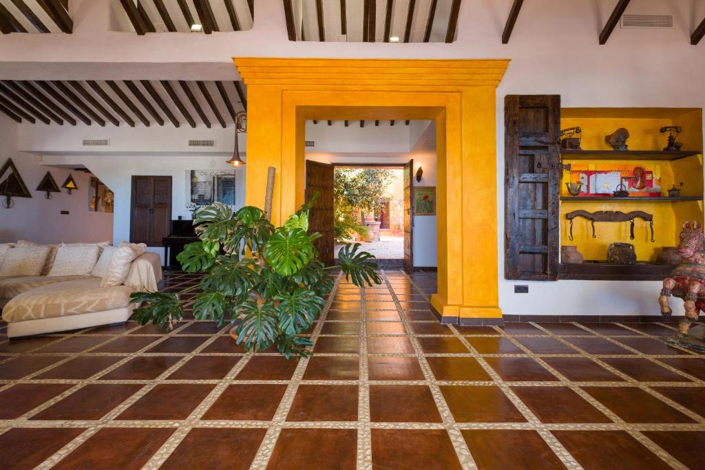 a living room with yellow columns and a couch at Cortijo Boutique Marbella in Marbella