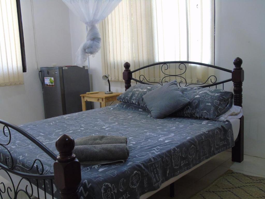 Postel nebo postele na pokoji v ubytování IDC Guest House